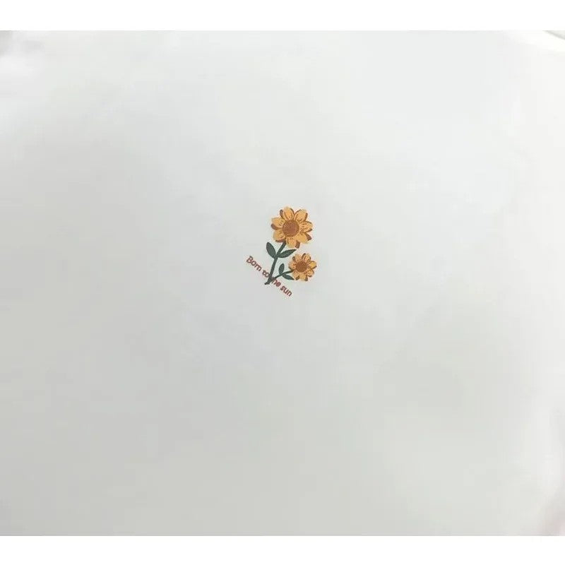 Detailed shot of the small, delicate sunflower graphic printed on the back of the neck.