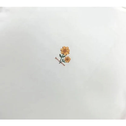 Detailed shot of the small, delicate sunflower graphic printed on the back of the neck.