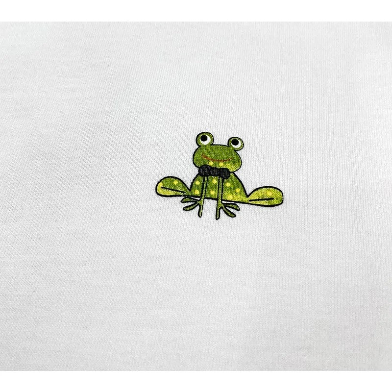Close-up of the small artistic frog illustration on the left chest.
