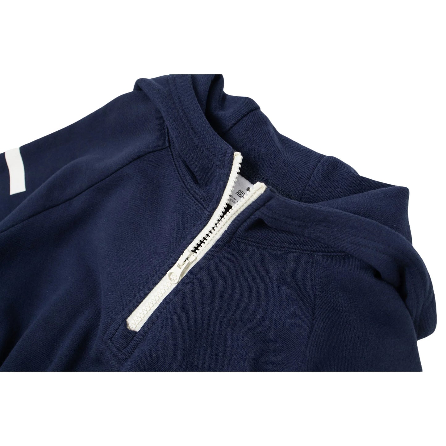 Close-up of the white contrast half-zip and the soft hood construction.