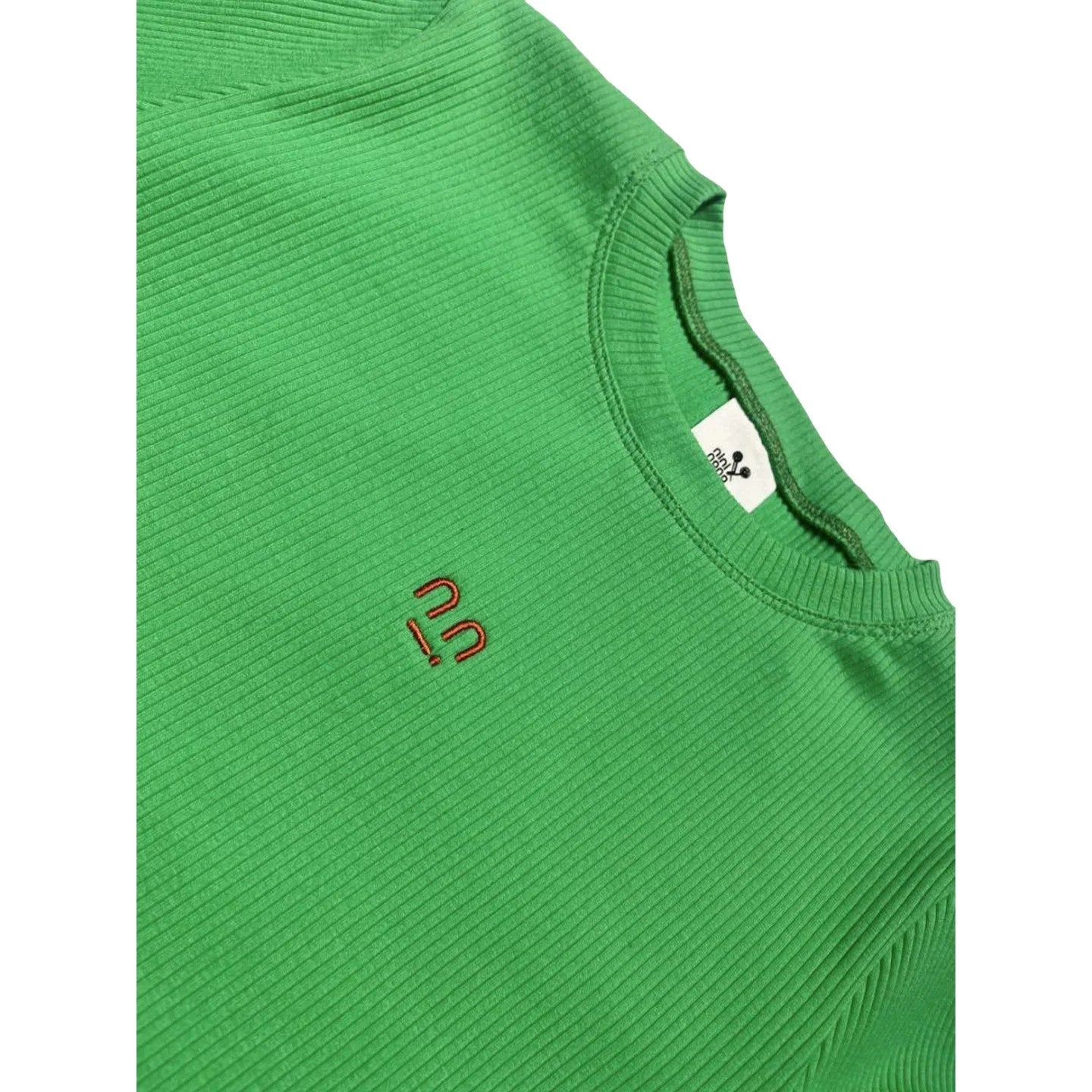 Close-up of the ribbed crew neckline and the orange smiley face embroidery on the bold green Ogender tee.