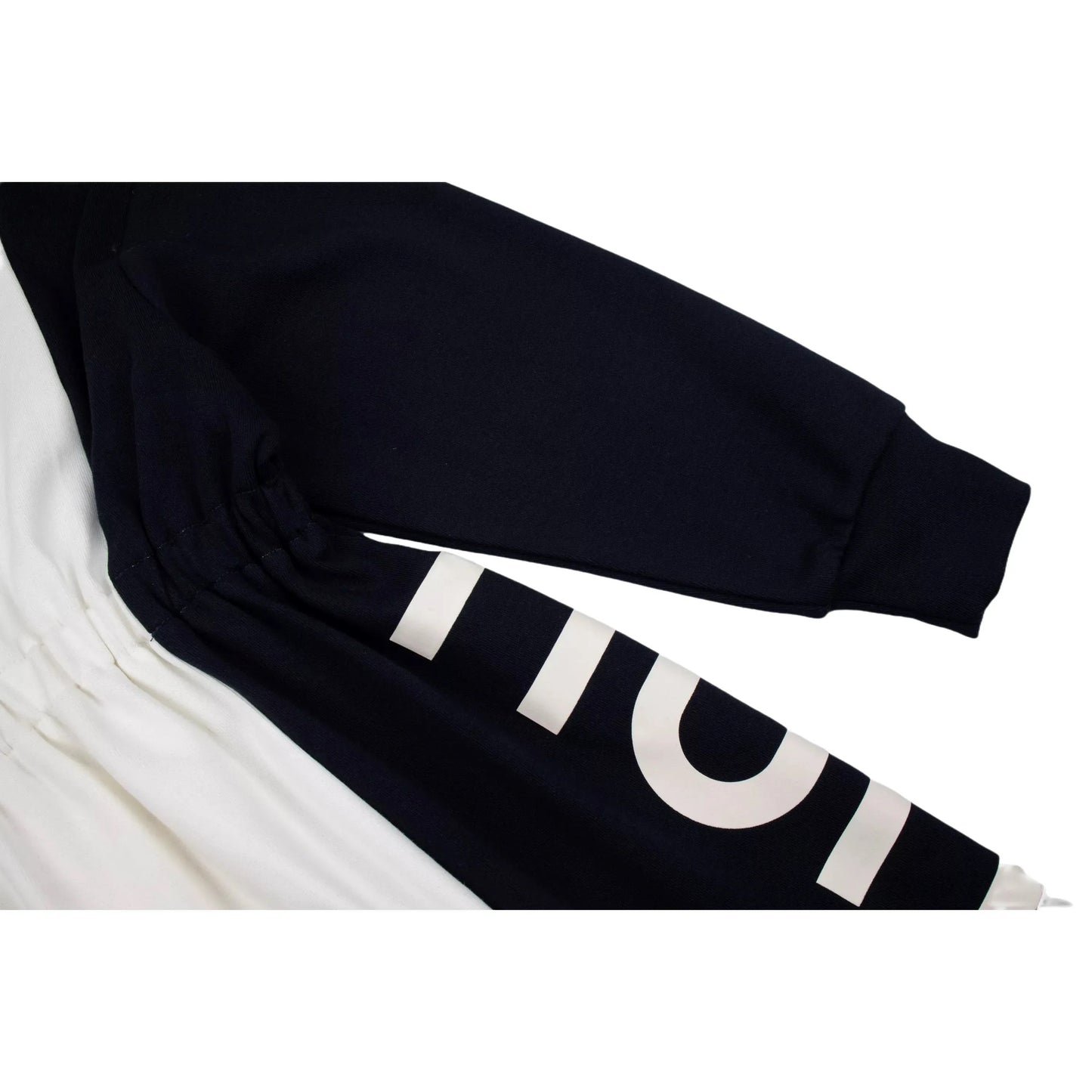 Detailed shot of the 340 GSM fabric and the rubberized branding near the cuff.