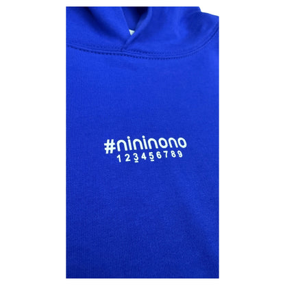 Close-up of the abstract number print and transparent tape logo effect on the chest of the blue