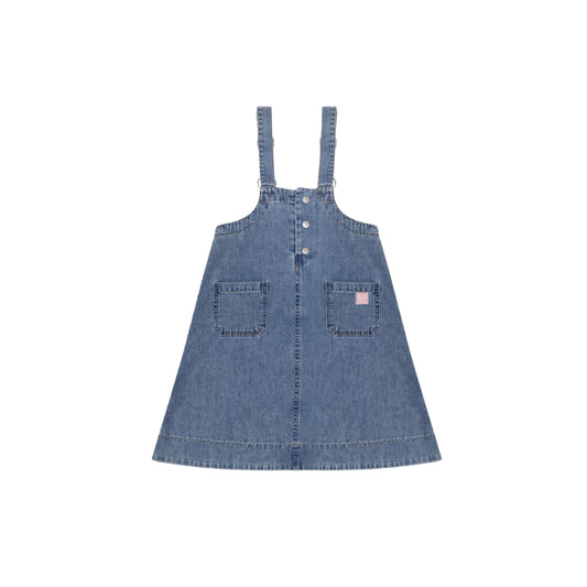 Front view of the indigo denim pinafore dress with side pockets and pink smiley detail.