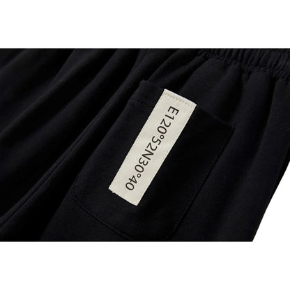 Detailed view of the signature brand woven label on the jogger's back pocket.