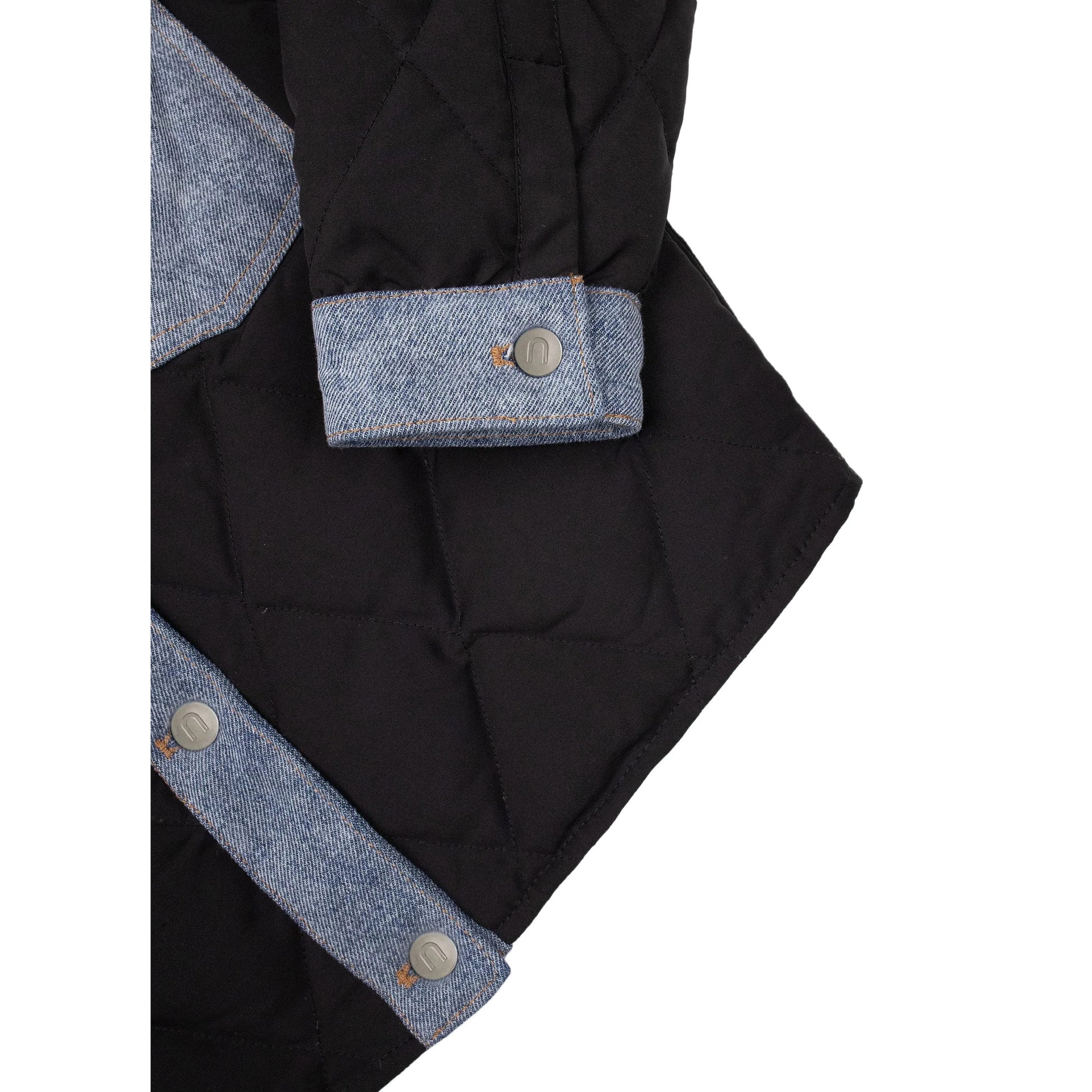Detailed shot of the denim sleeve cuffs and branded metal buttons on the junior puffer coat.
