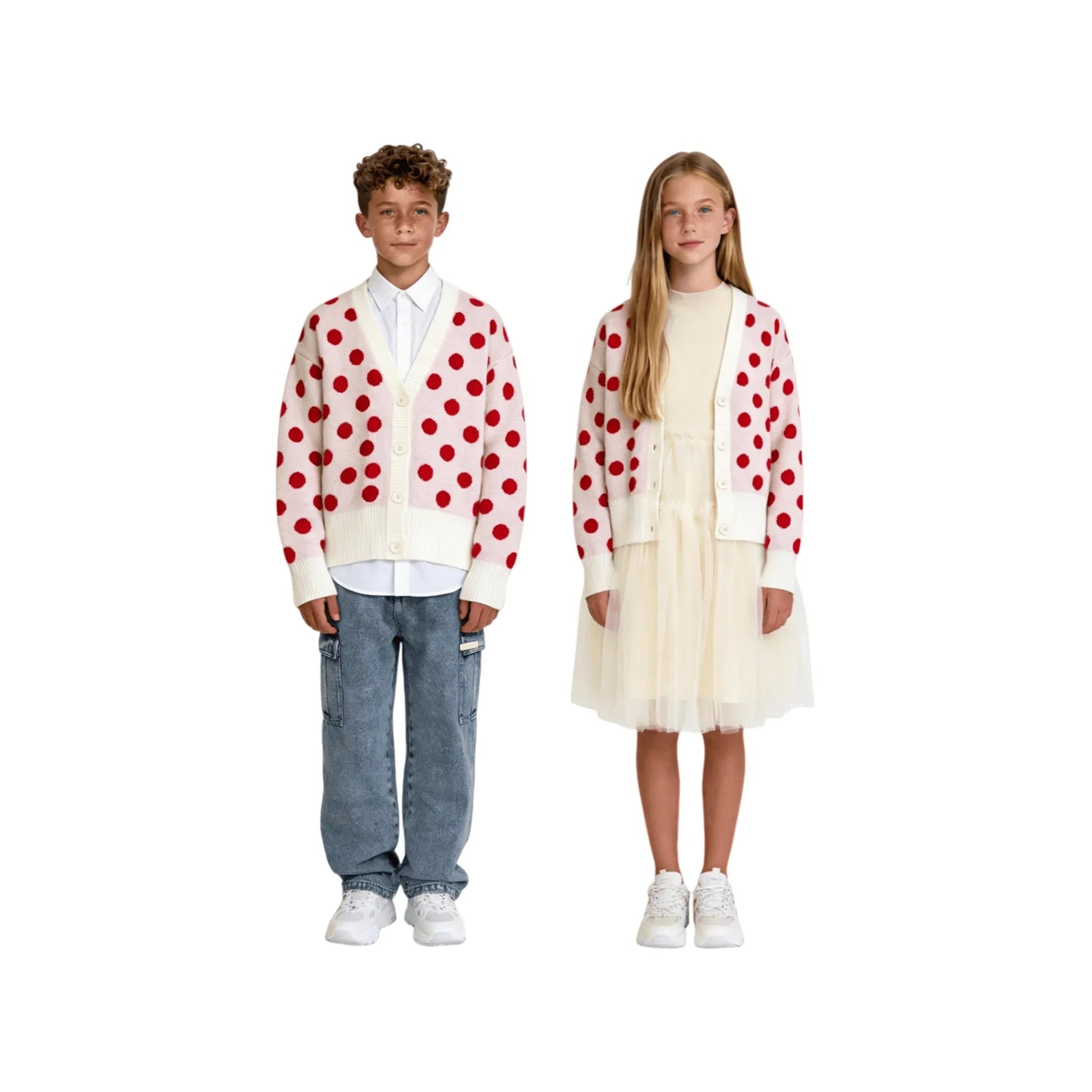 Full-body shot of boy in Ogender polka dot cardigan with denim jeans, and girl in the same cardigan layered over a knit-to-chiffon patchwork dress