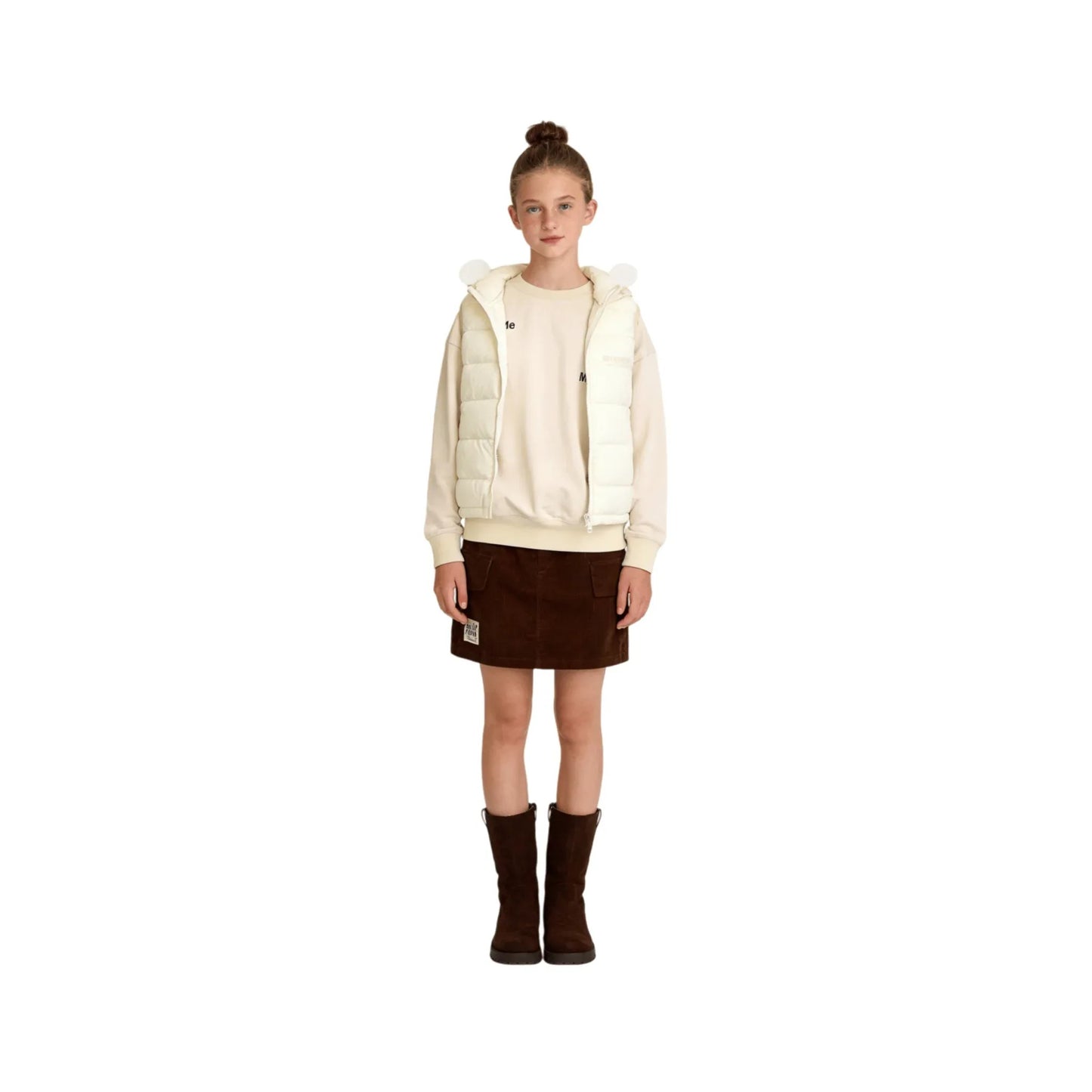 A young girl modeling the cream hooded quilted vest with rounded ears.