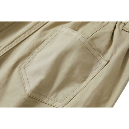Detailed view of the reinforced rear patch pocket with tonal stitching on sage green trousers.