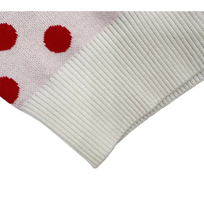 Close-up of the white ribbed hem and high-quality knit texture of the cardigan.