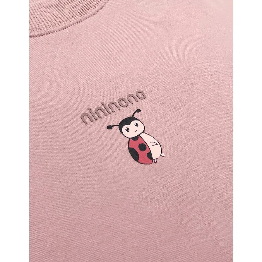 Close-up of the ribbed neckline and the "nininono" ladybird print.
