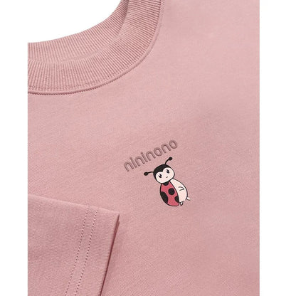 etailed shot of the hand-drawn ladybird graphic on the pink fabric.