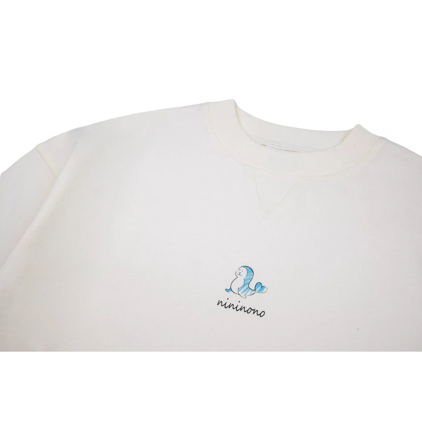 Close-up of the reinforced crew neck and the artistic dolphin print on the chest.