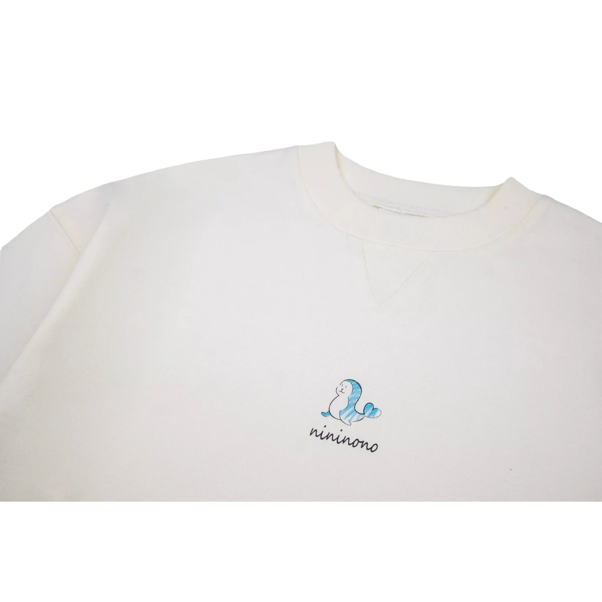 Close-up of the reinforced crew neck and the artistic dolphin print on the chest.
