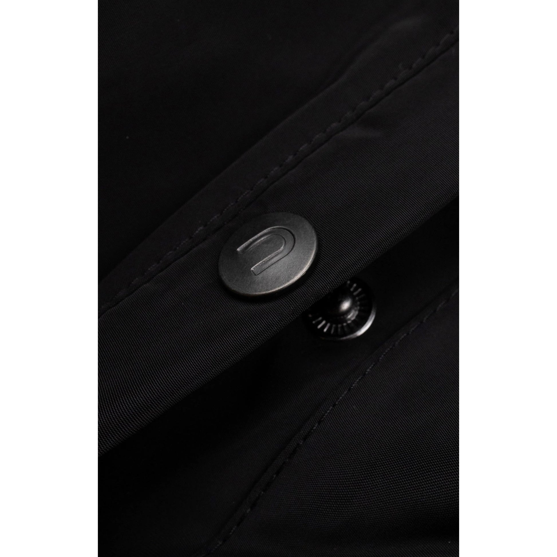 Detailed shot of the high-quality matte metal snap buttons on the front placket.