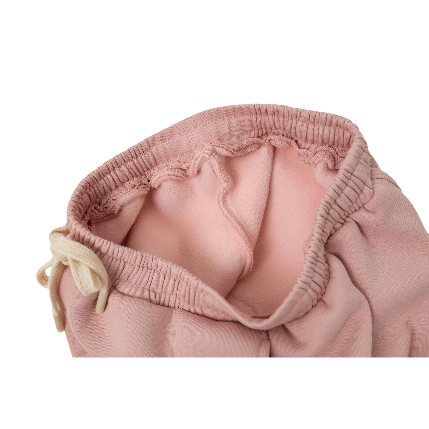 Close-up of the thick, anti-static fleece lining inside the dusty pink joggers for thermal warmth