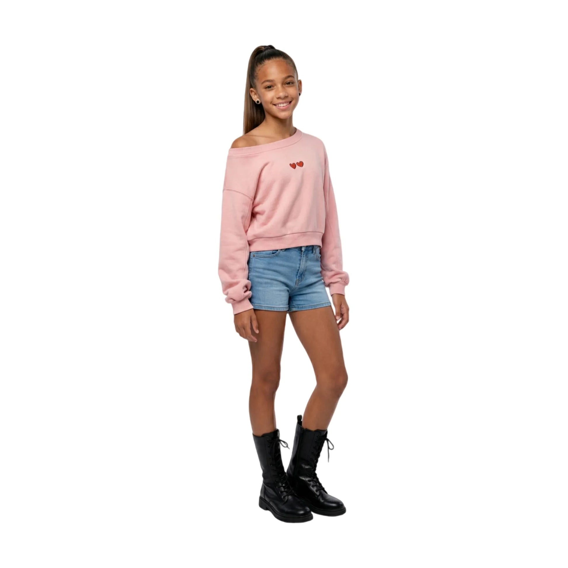 Full-body shot of a girl model wearing the pink cropped sweatshirt, styled for a high-street urban look.