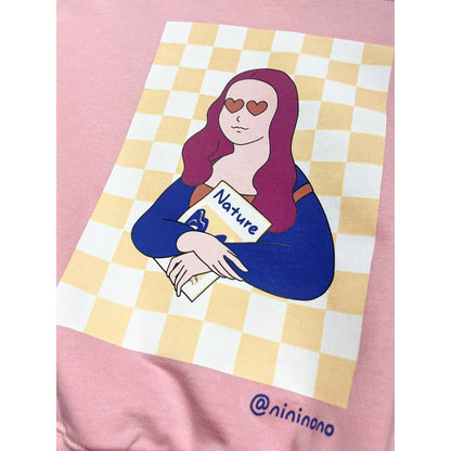 Close-up of the vibrant signature urban character print on the back of the pink sweatshirt.