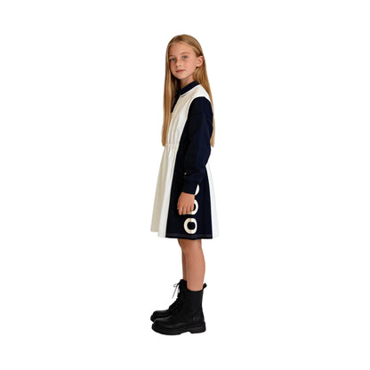 Side view showing the rubberized nini logo print on the color-block polo dress.