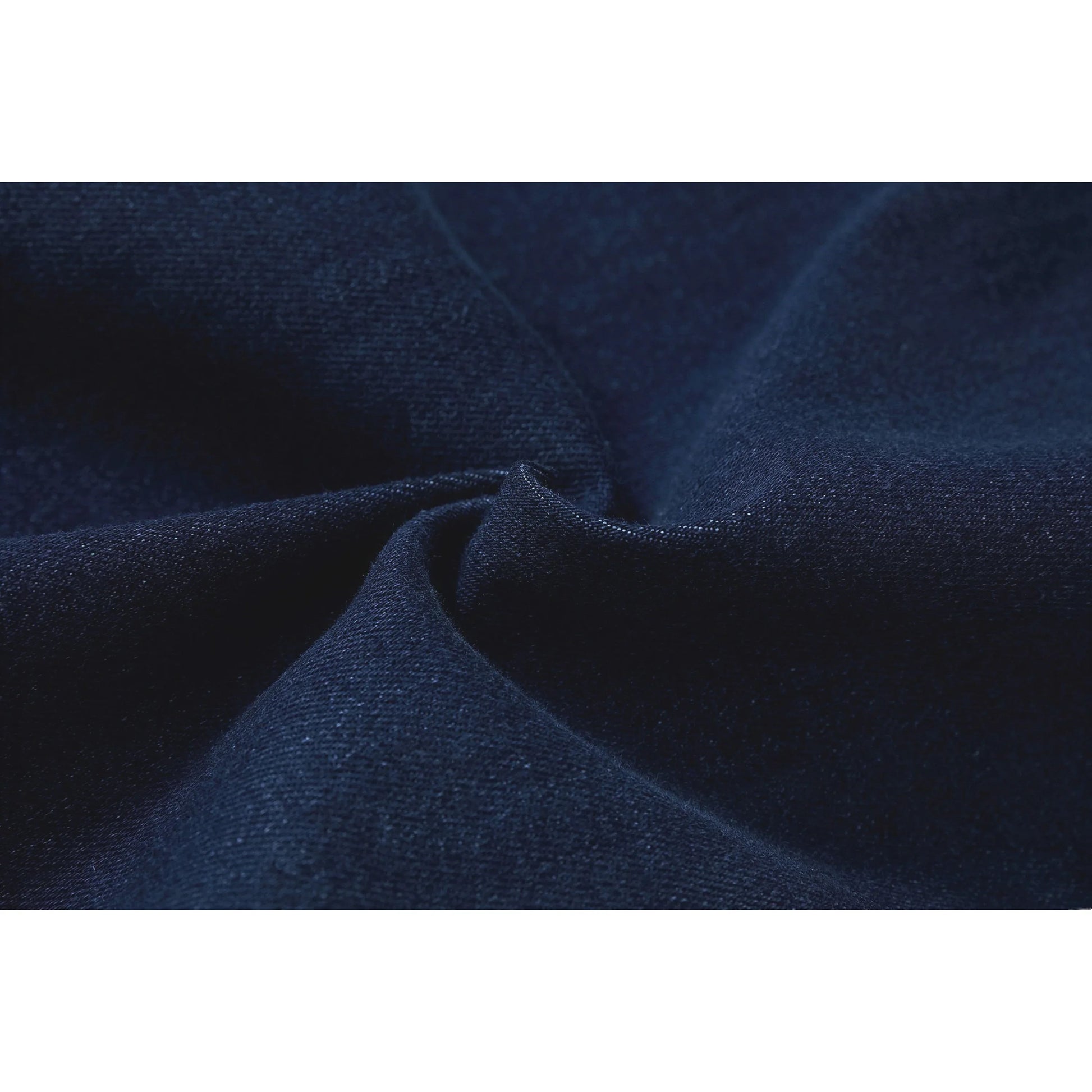 Macro view of the soft-touch denim fabric texture in vintage dark blue.