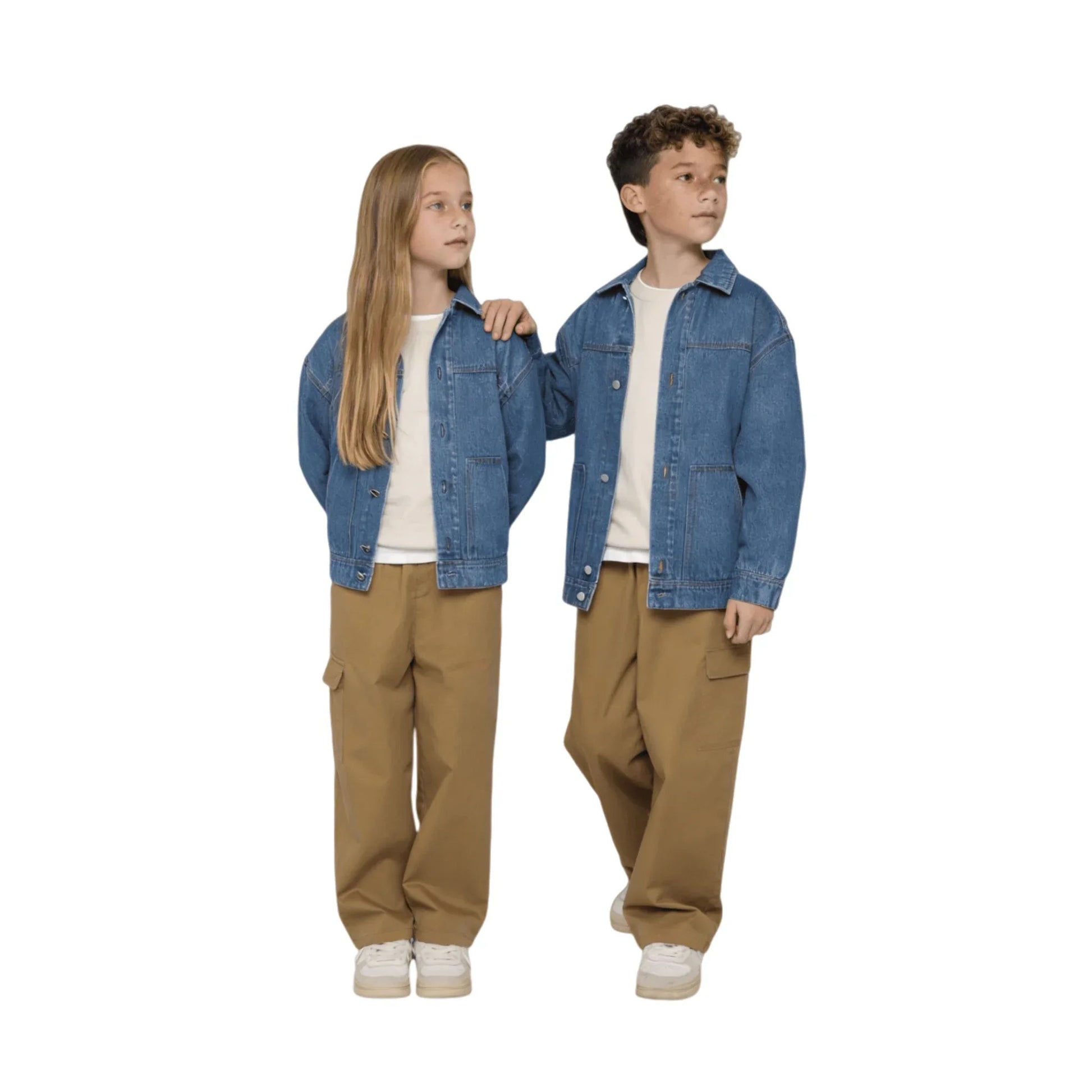 A boy and a girl modeling the unisex oversized denim jacket to showcase its versatile fit.