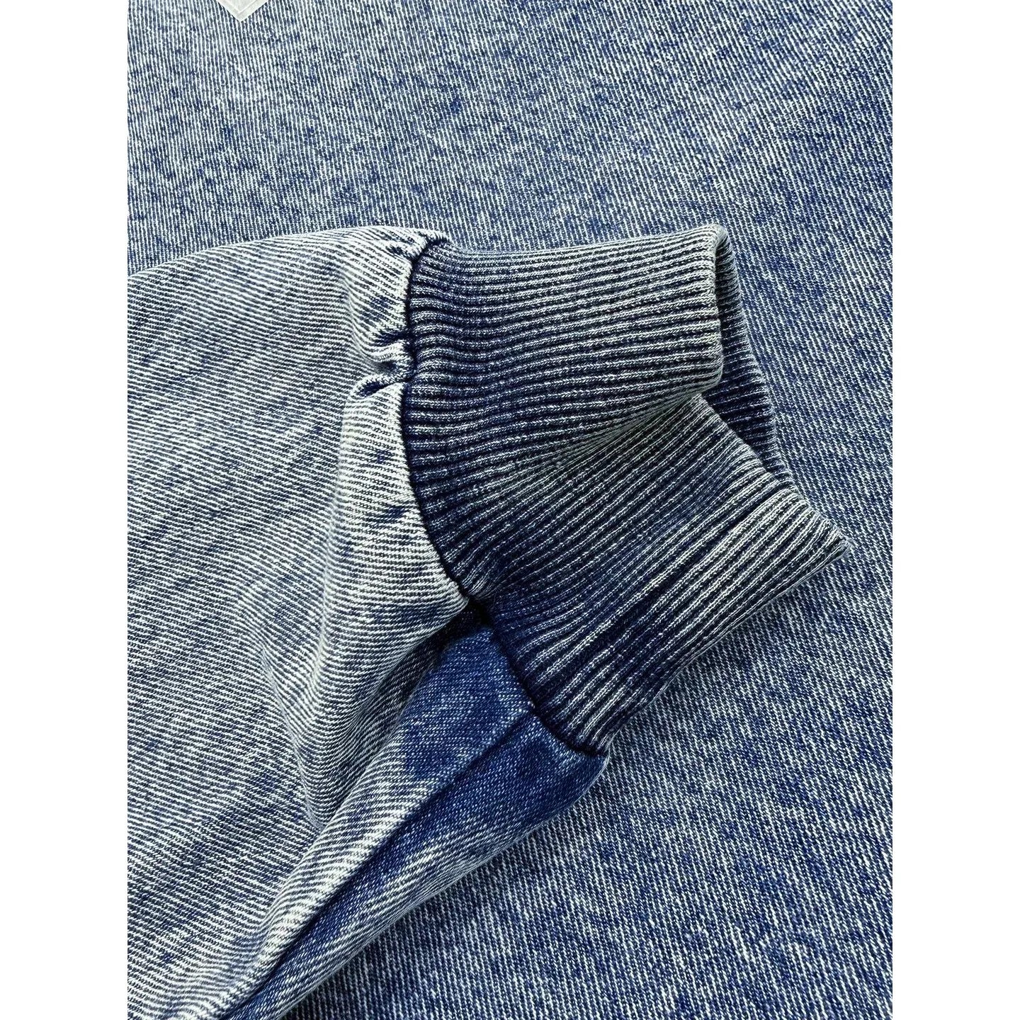 Close-up of the durable ribbed cuffs and vintage washed 100% cotton fabric on the Ogender denim pullover.