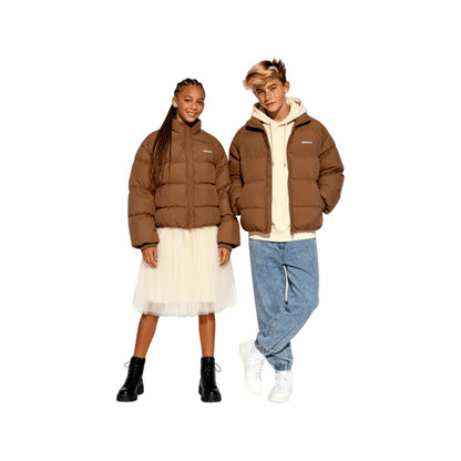 Teens models showcasing the oversized Earth Brown premium down jacket.