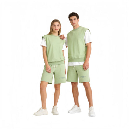 A male and female model styling the Sage Green tank and shorts as a coordinated streetwear look.