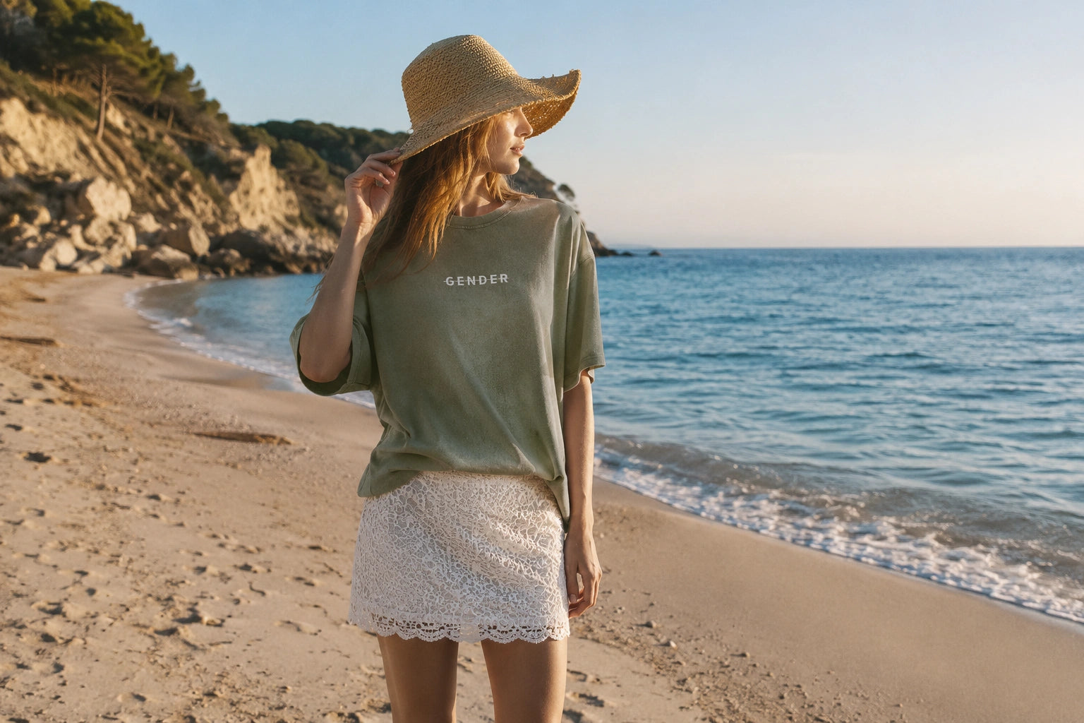 OGender unisex summer collection featuring a vintage khaki washed t-shirt styled with a white lace skirt in a beach lifestyle campaign