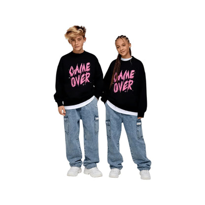 A boy and a girl modeling the unisex black streetwear pullover for a relaxed fit.