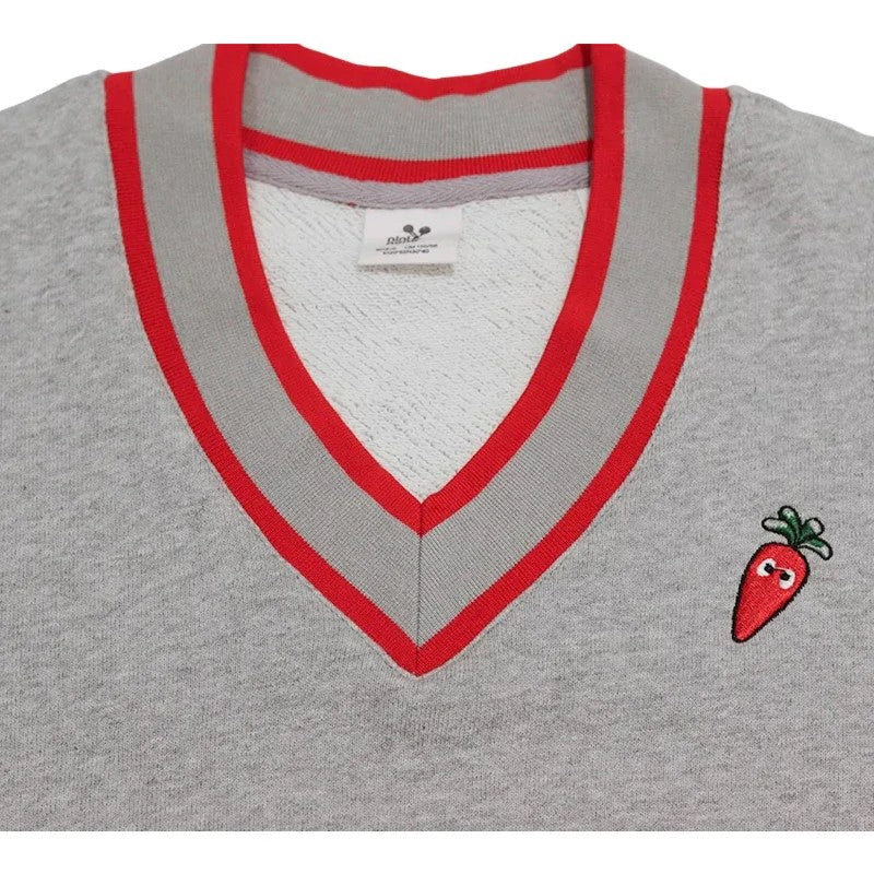 Close-up of the contrast-colored striped V-neckline and the carrot embroidery detail.