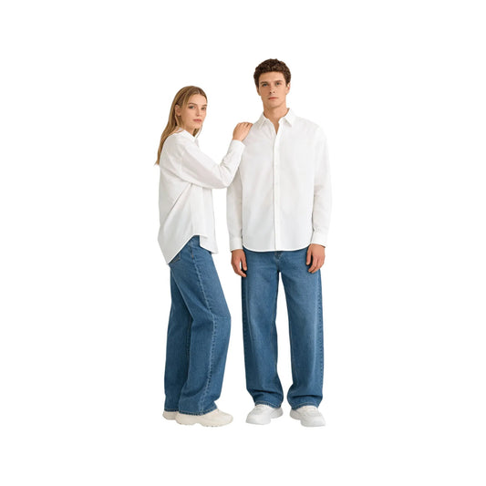 Male and female models wearing the oversized white shirts paired with denim jeans for a minimalist look.