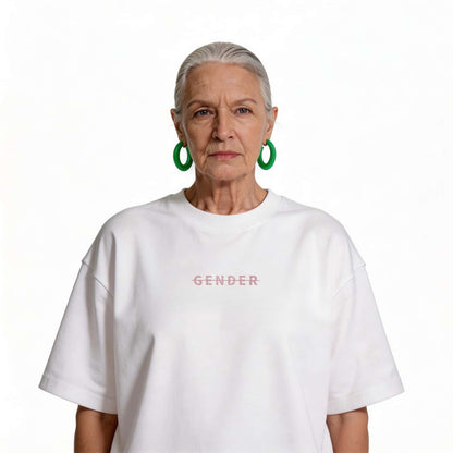 Fashionable senior female model wearing Ogender white oversized cotton tee, demonstrating ageless and gender-neutral streetwear style.